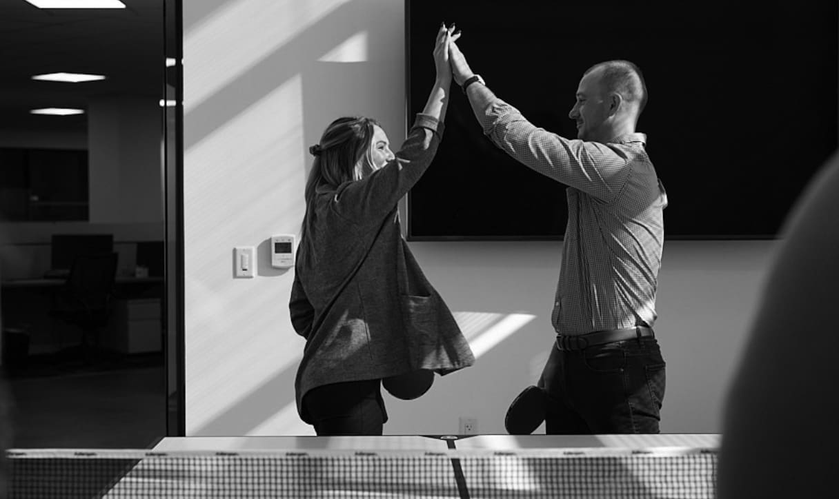 Two Wiss team members celebrating a successful accounting technology implementation in the office