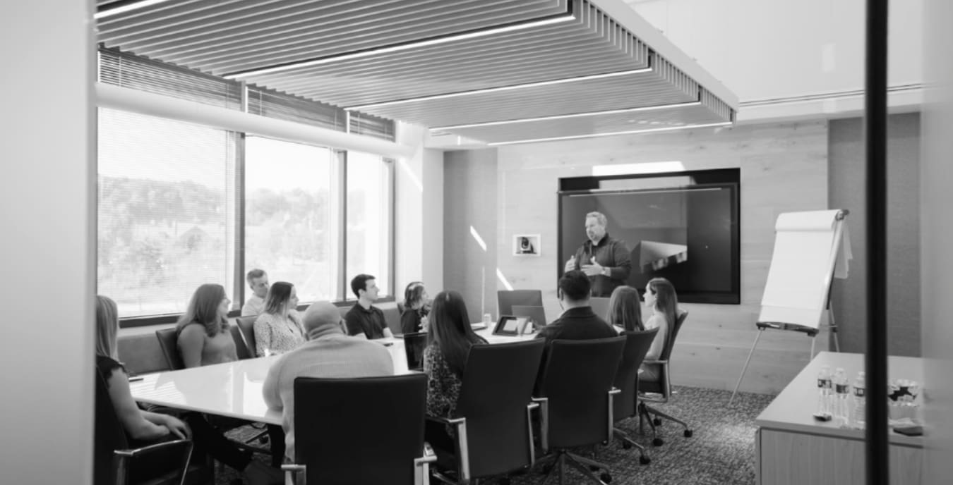 Wiss leader presenting accounting technology findings to a full team in a corporate conference room